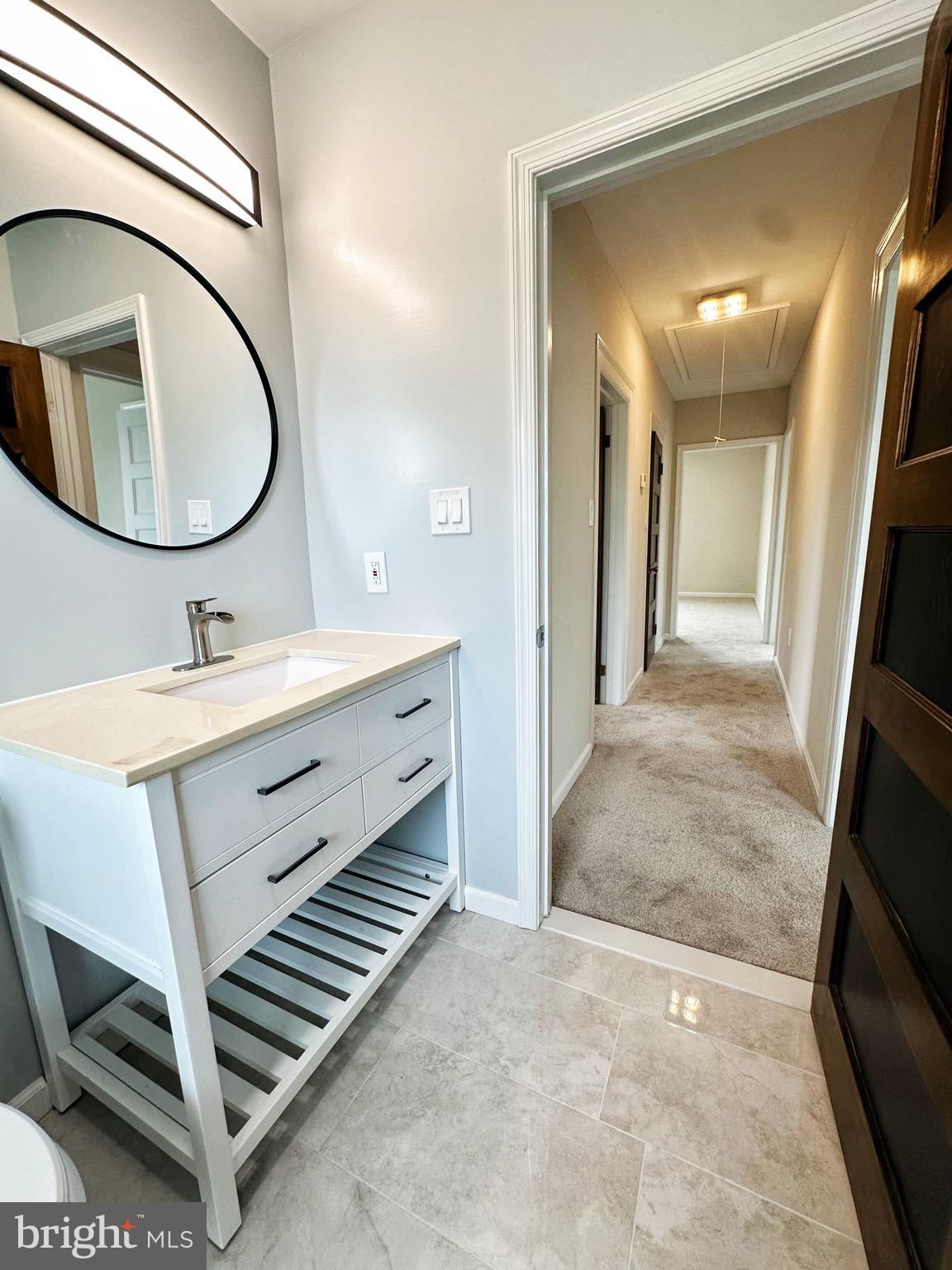 603 Brookwood Road Baltimore, MD 21229 - Photo 11 of 33 a bathroom with a sink a mirror and a bathtub
