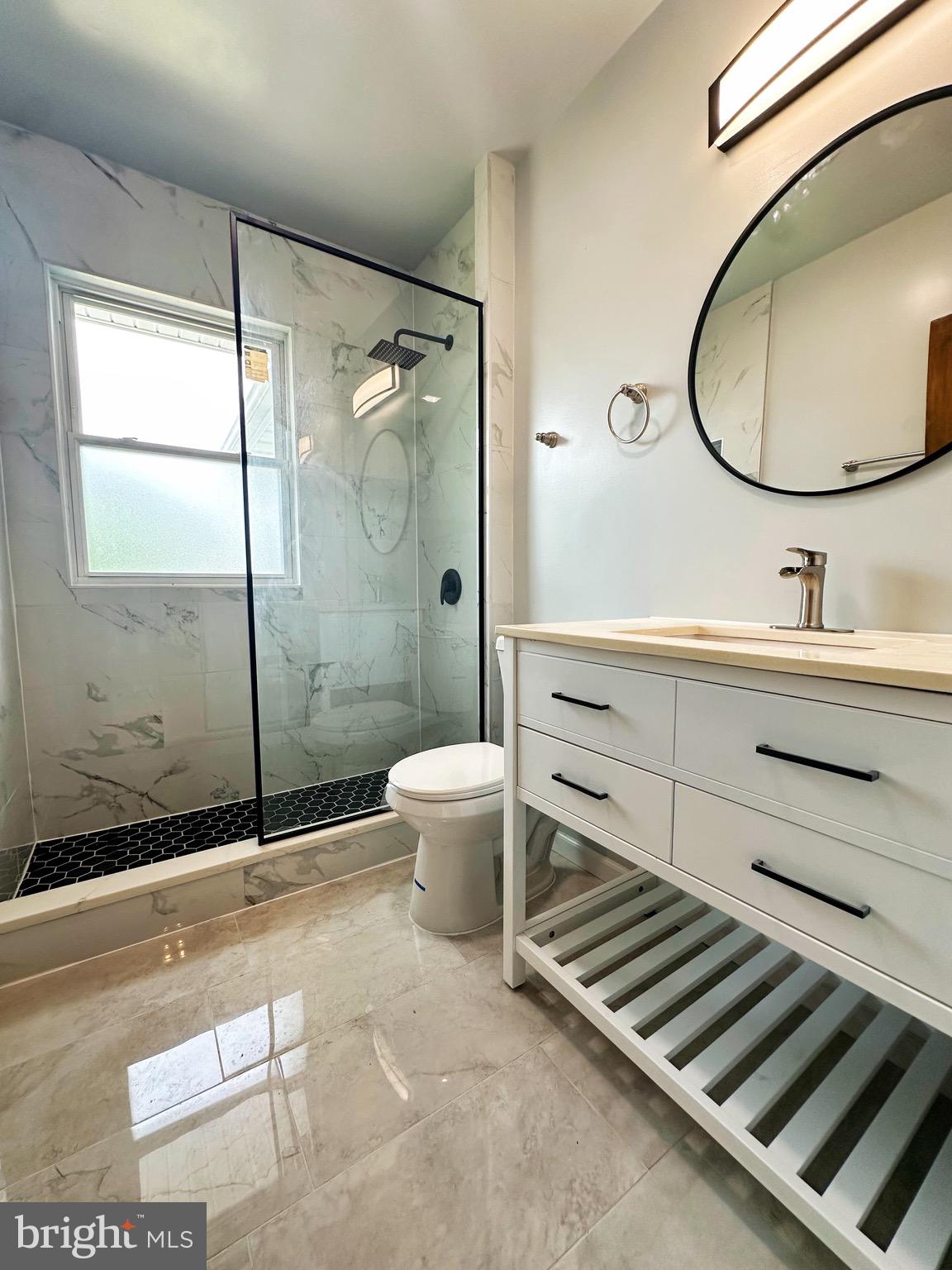 603 Brookwood Road Baltimore, MD 21229 - Photo 12 of 33 a bathroom with a sink mirror vanity and toilet