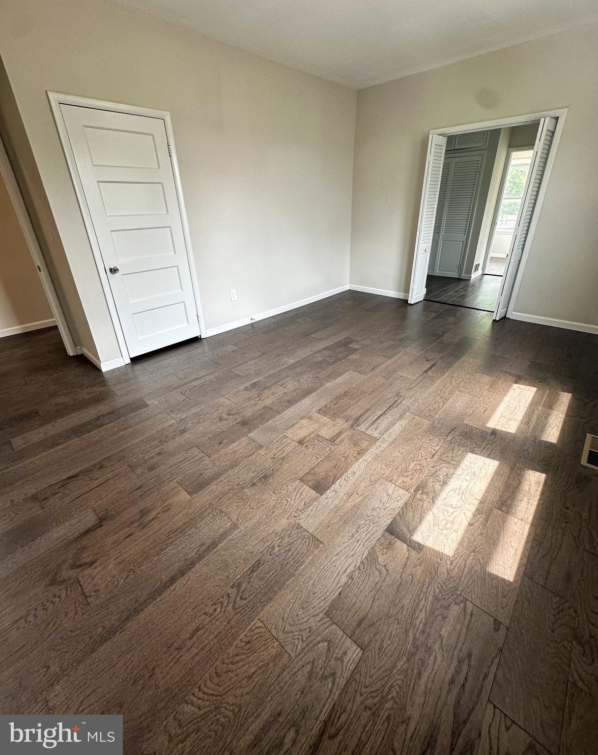 603 Brookwood Road Baltimore, MD 21229 - Photo 15 of 33 an empty room with wooden floor and door