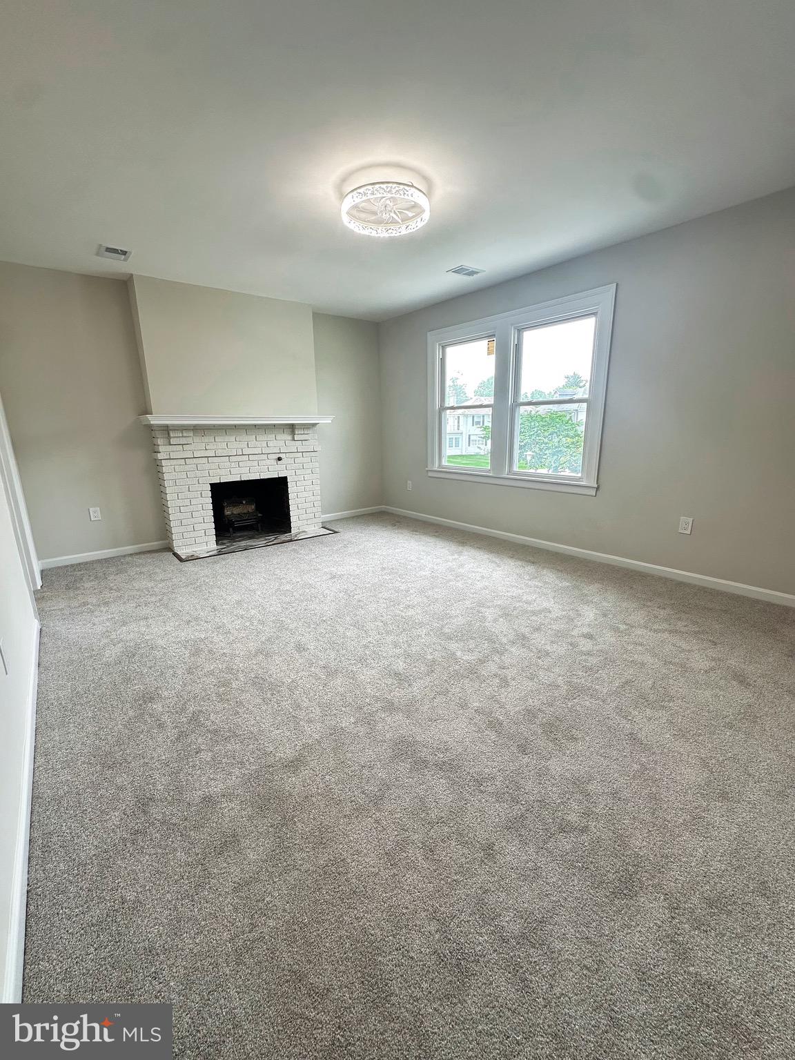 603 Brookwood Road Baltimore, MD 21229 - Photo 20 of 33 an empty room with windows and fireplace