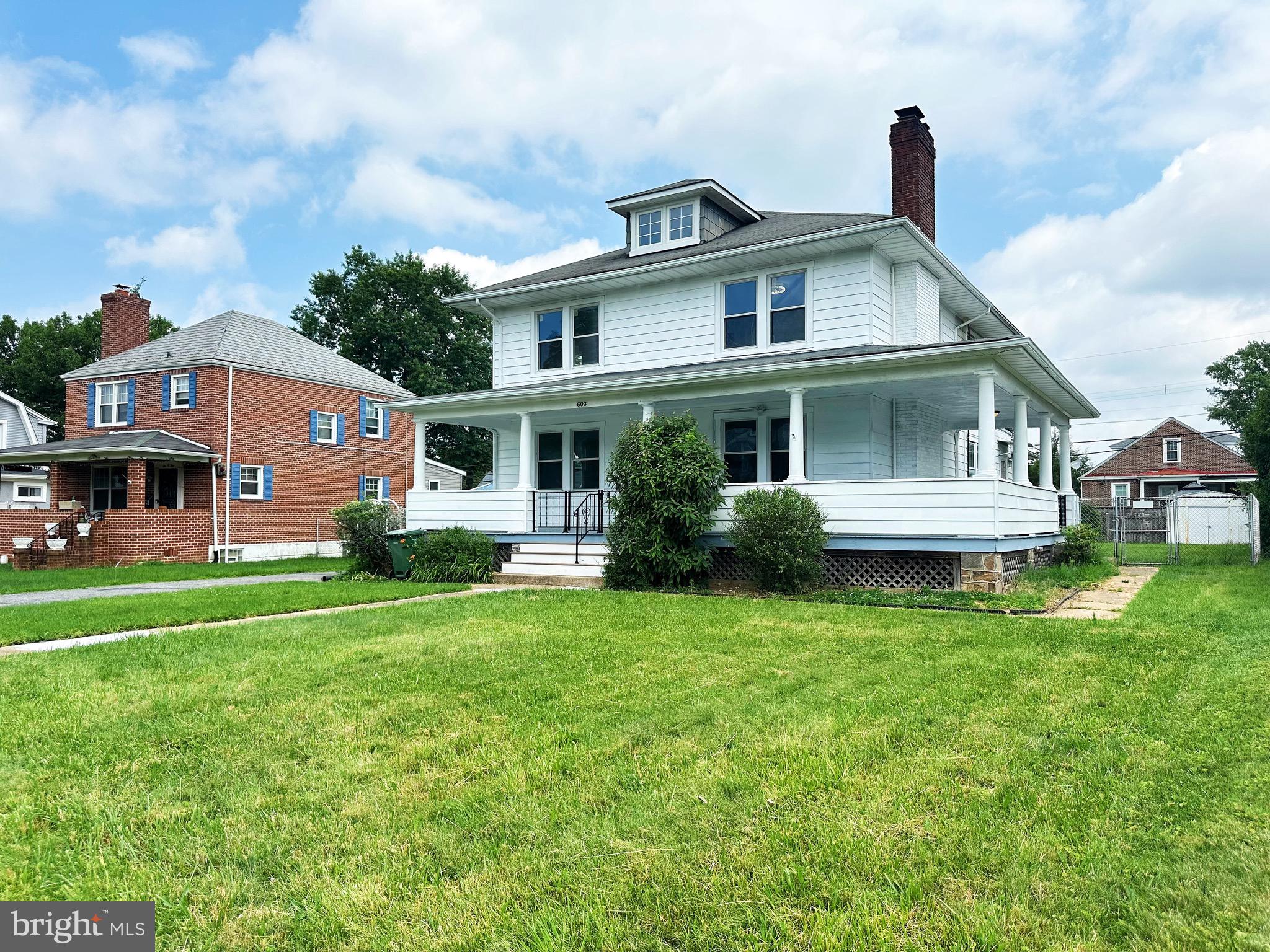603 Brookwood Road Baltimore, MD 21229 - Photo 2 of 33 a front view of a house with a yard table and chairs