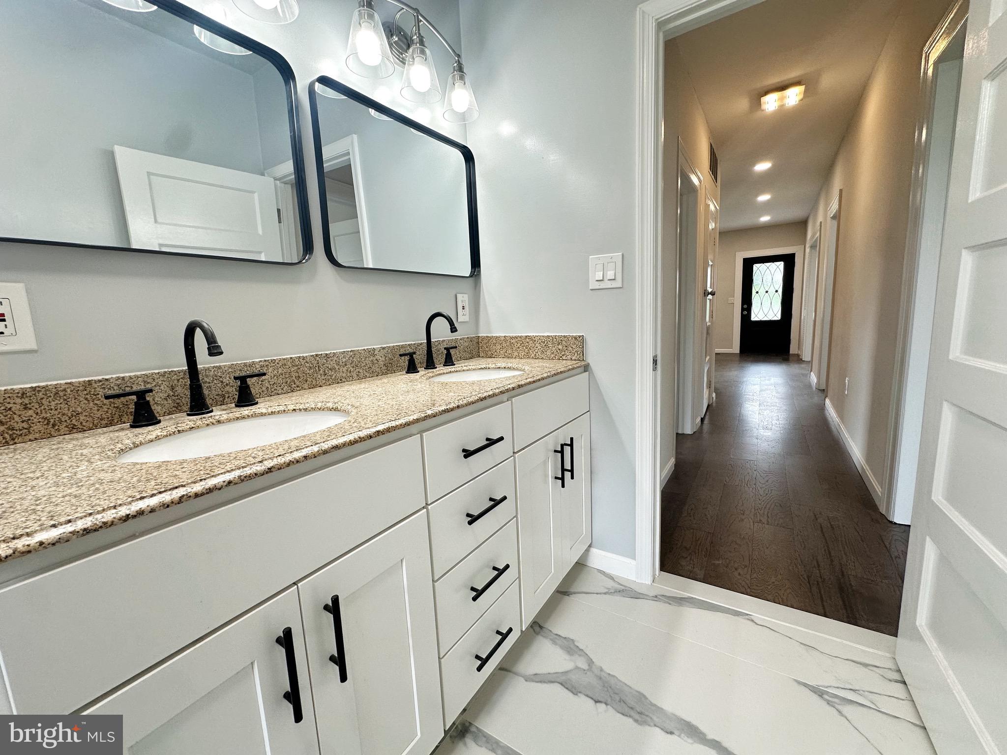 603 Brookwood Road Baltimore, MD 21229 - Photo 26 of 33 a bathroom with a sink and a mirror