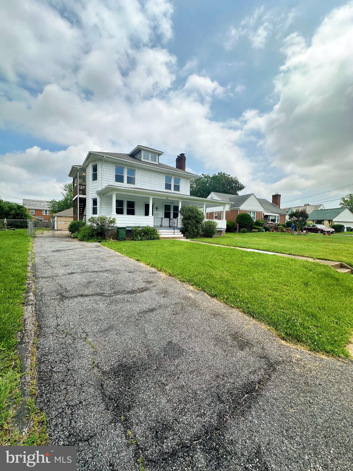 603 Brookwood Road Baltimore, MD 21229 - Photo 3 of 33 a view of a big house with a big yard and large trees