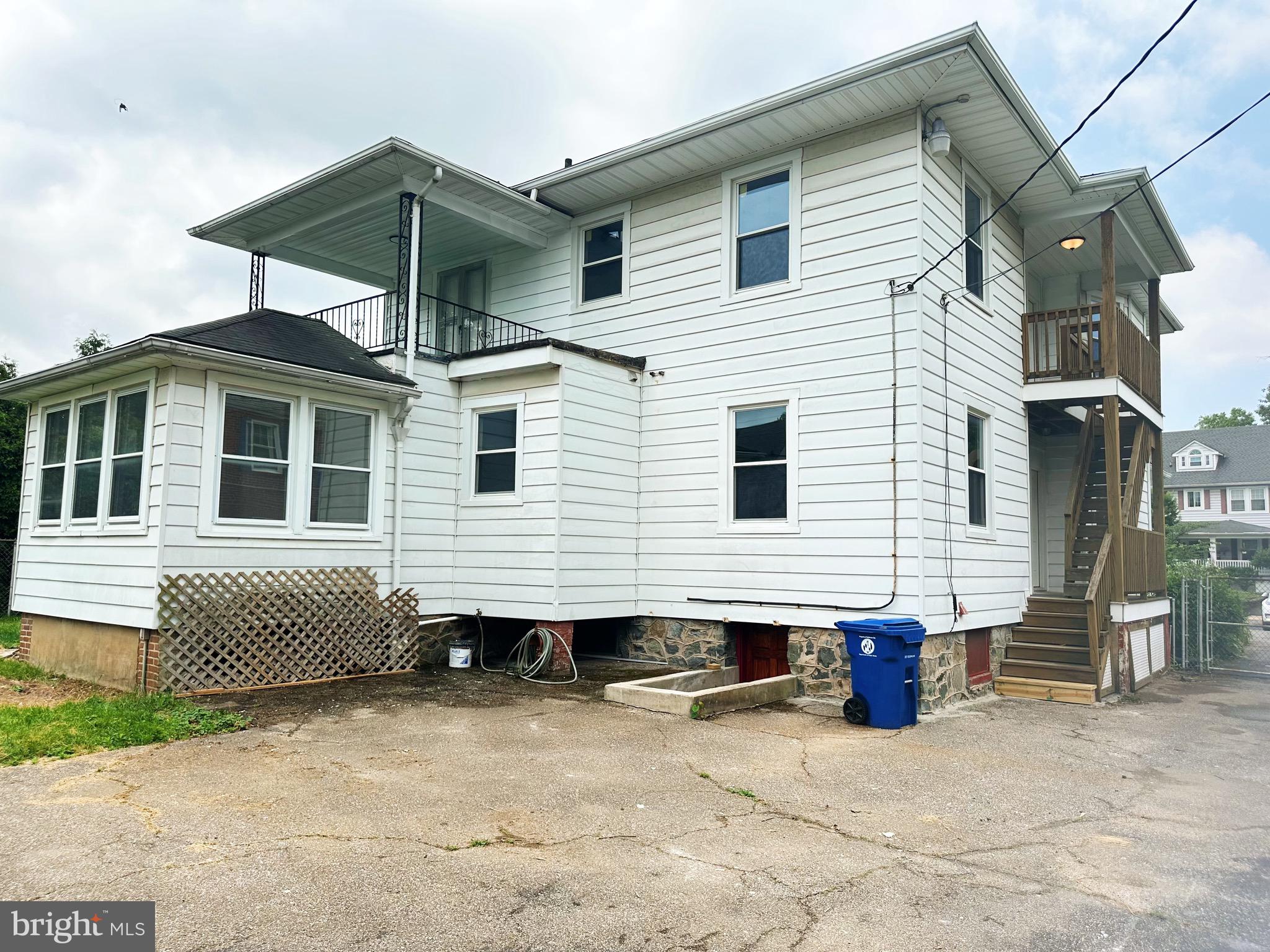 603 Brookwood Road Baltimore, MD 21229 - Photo 32 of 33 a view of a white house with many windows next to a yard