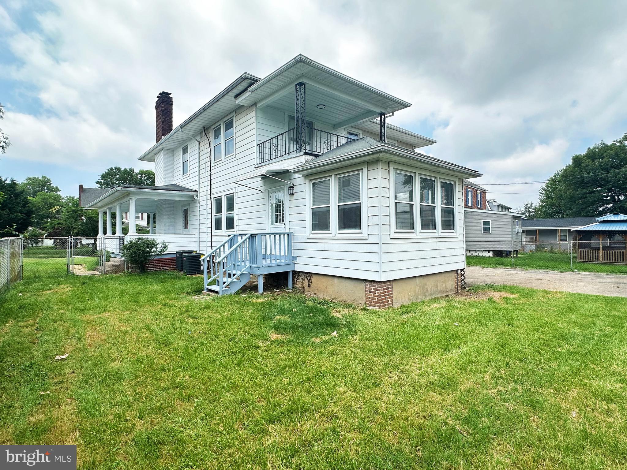 603 Brookwood Road Baltimore, MD 21229 - Photo 4 of 33 a front view of a house with a yard table and chairs