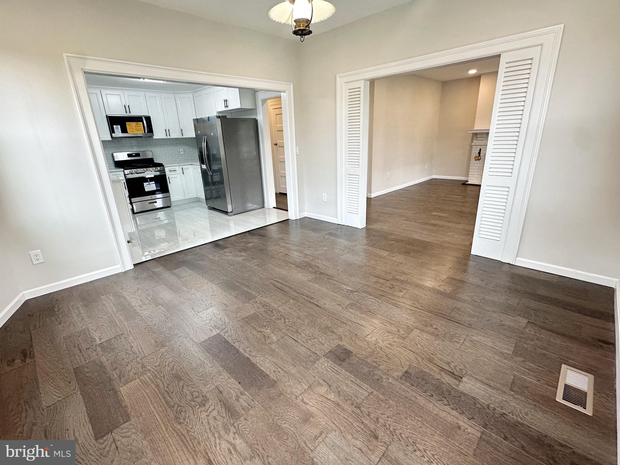 603 Brookwood Road Baltimore, MD 21229 - Photo 7 of 33 an empty room with wooden floor cabinet and closet