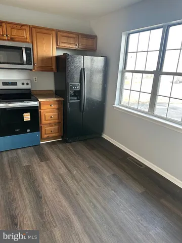 a kitchen with stainless steel appliances a refrigerator and a stove