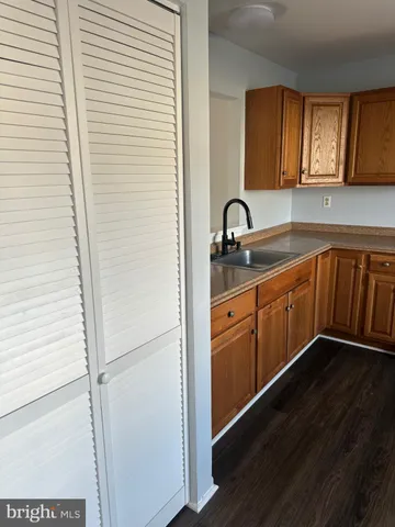 a kitchen with a sink a refrigerator and window