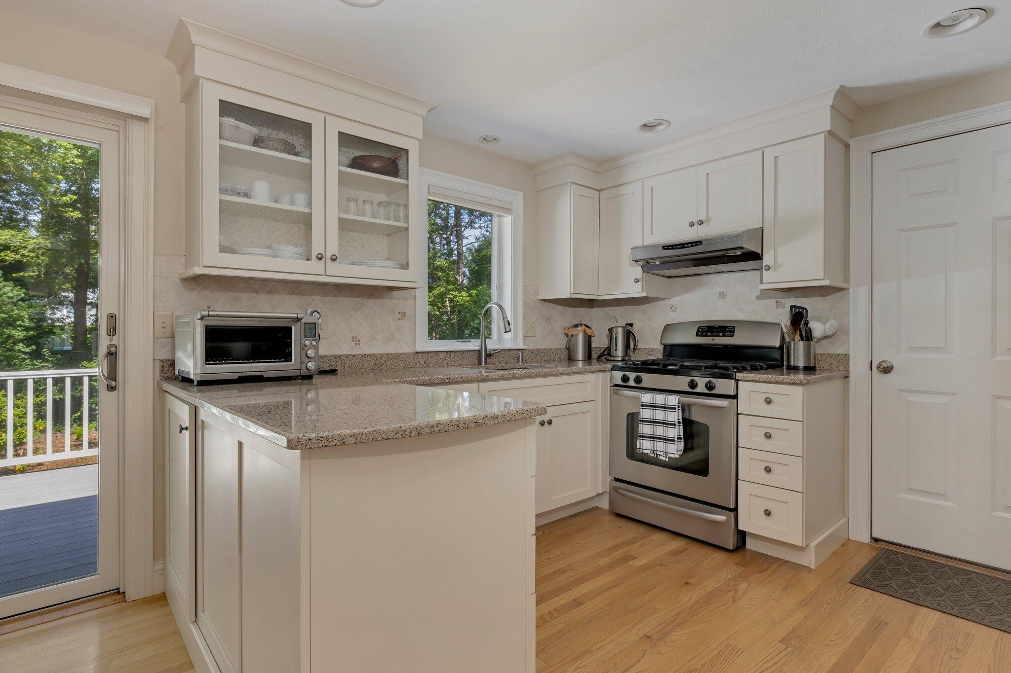 79 Mountwood Road Marstons Mills, MA 02648 - Photo 13 of 33 a kitchen with stainless steel appliances granite countertop a stove and white cabinets