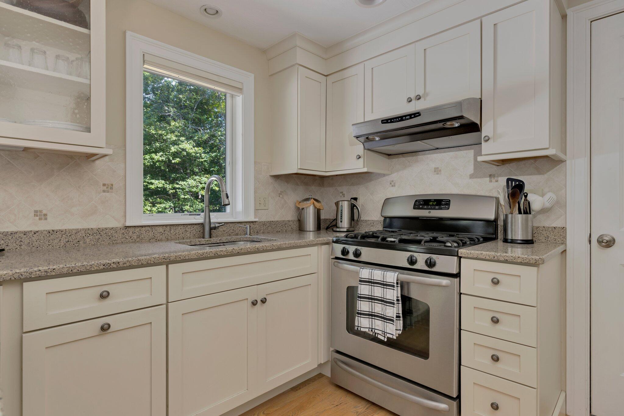 79 Mountwood Road Marstons Mills, MA 02648 - Photo 14 of 33 a kitchen with stainless steel appliances granite countertop white cabinets a sink and a stove