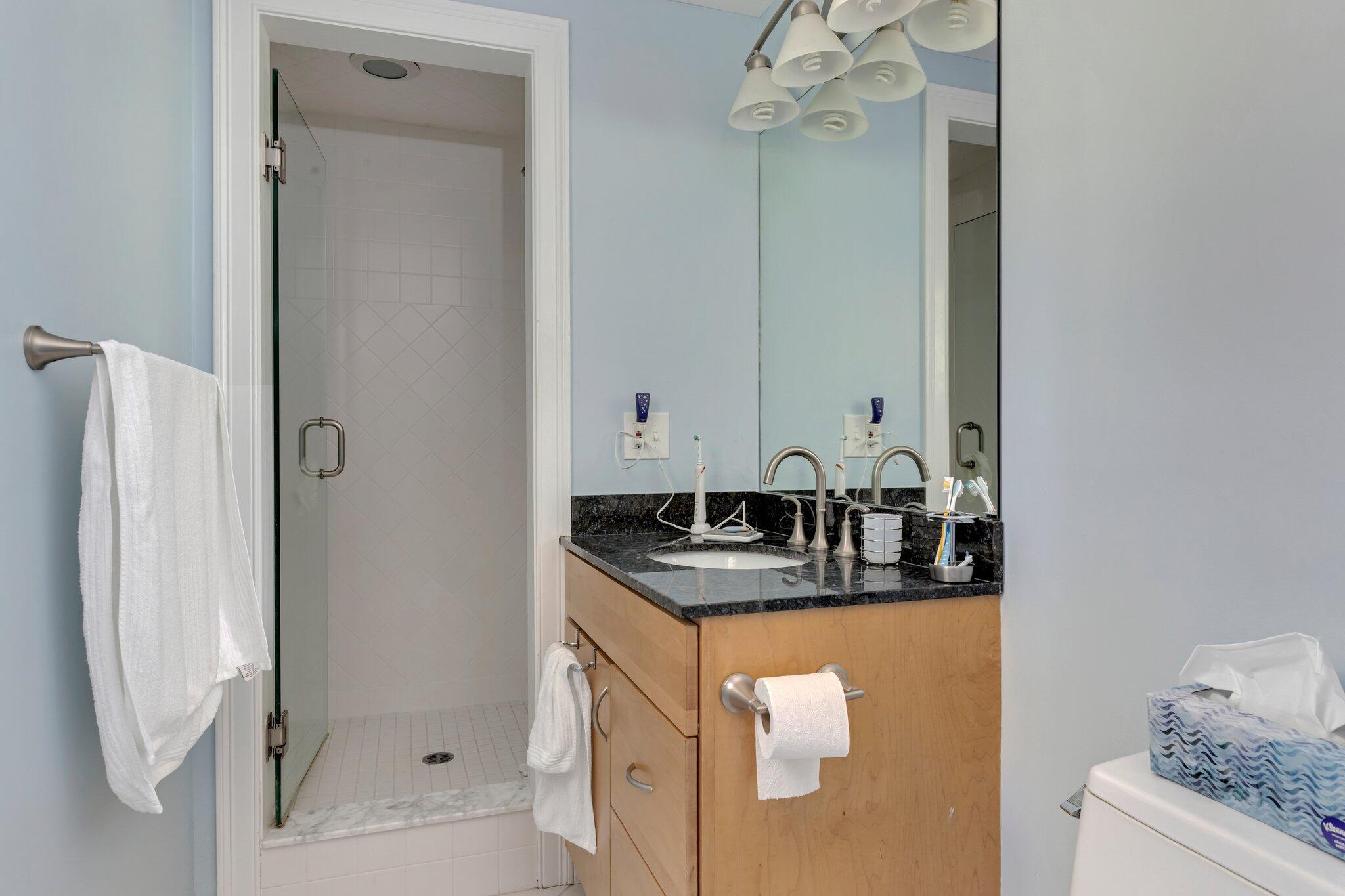 79 Mountwood Road Marstons Mills, MA 02648 - Photo 24 of 33 a bathroom with a granite countertop sink a mirror and shower