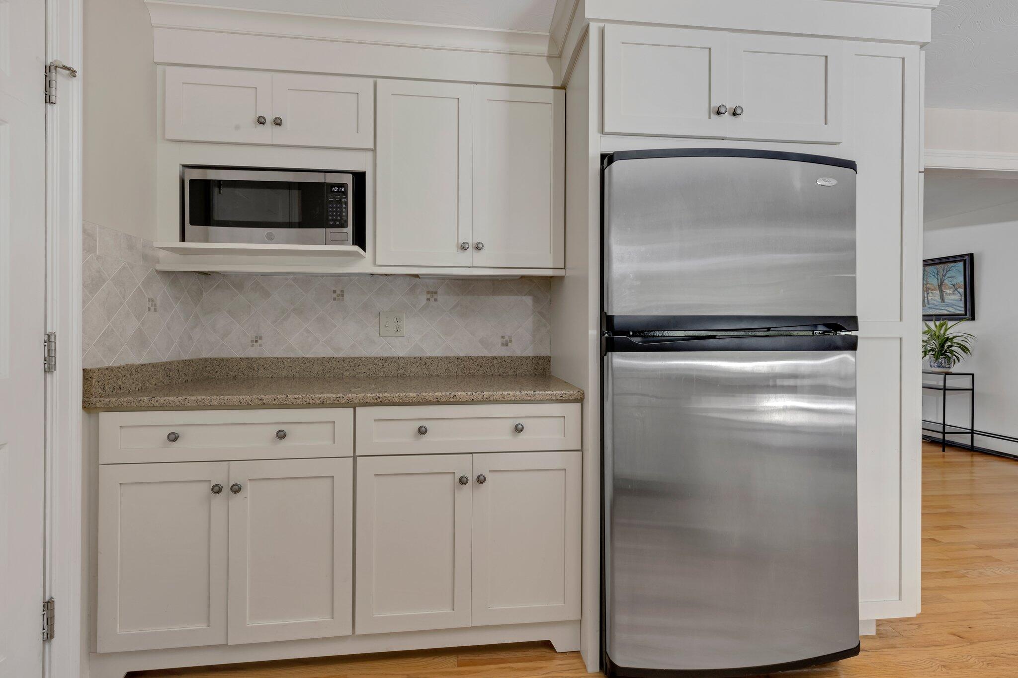 79 Mountwood Road Marstons Mills, MA 02648 - Photo 25 of 33 a kitchen with white cabinets and refrigerator