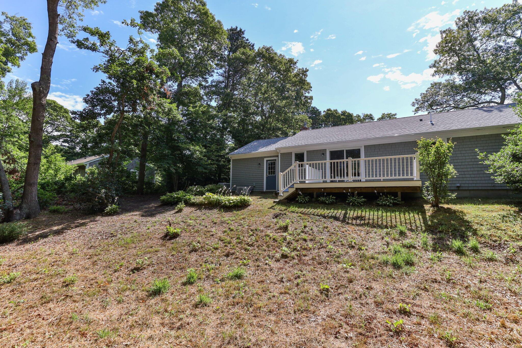 79 Mountwood Road Marstons Mills, MA 02648 - Photo 32 of 33 a house view with a backyard space