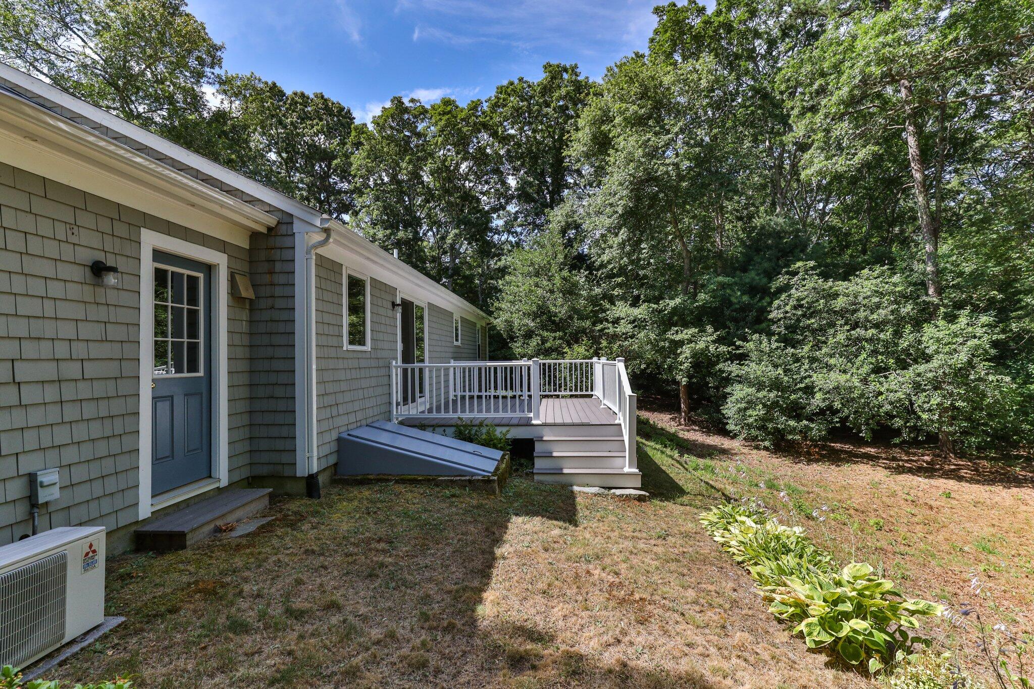 79 Mountwood Road Marstons Mills, MA 02648 - Photo 33 of 33 a view of a wooden deck and a yard