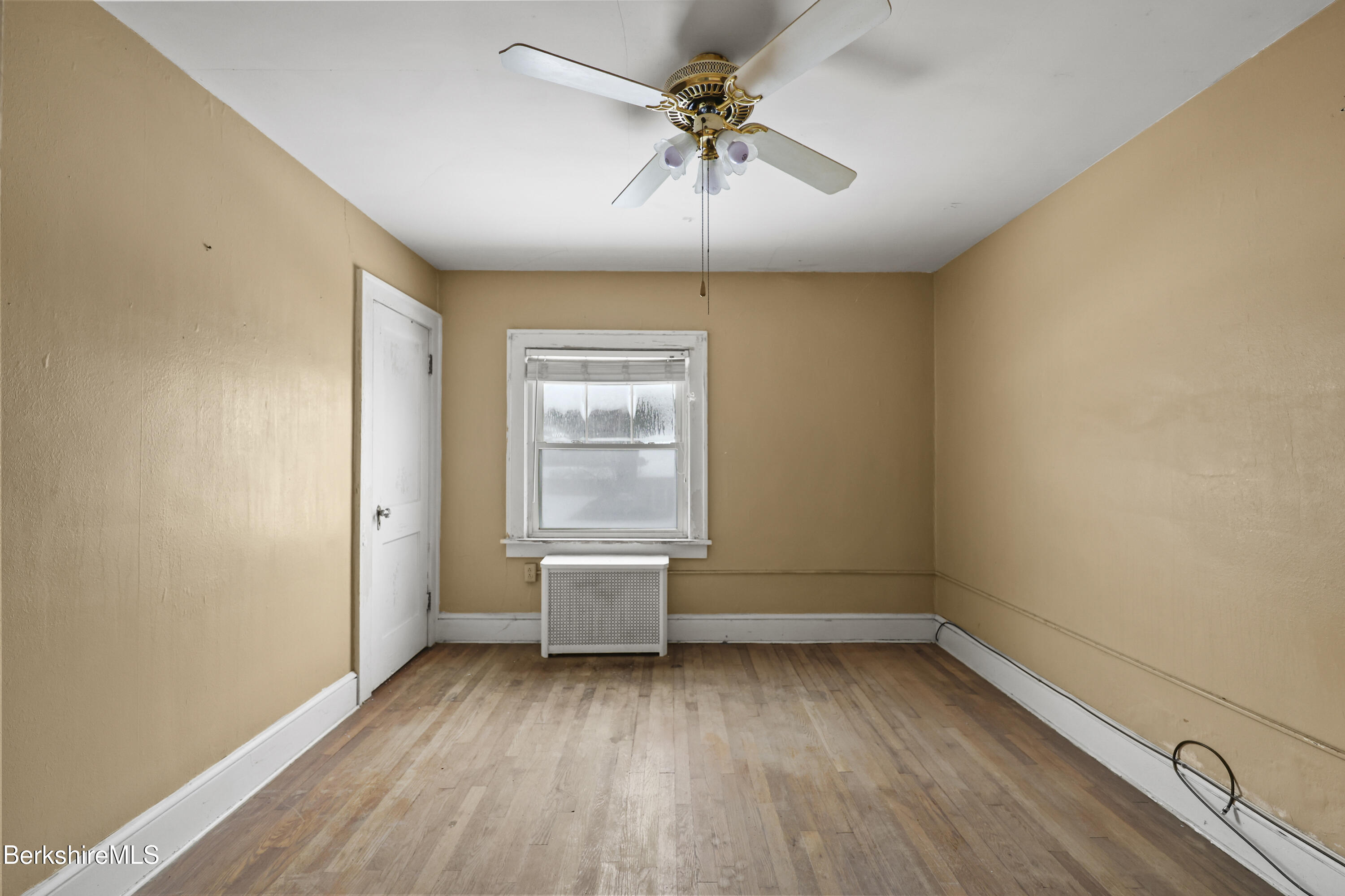 21 Ensign Avenue Pittsfield, MA 01201 - Photo 16 of 33 wooden floor in an empty room with a window