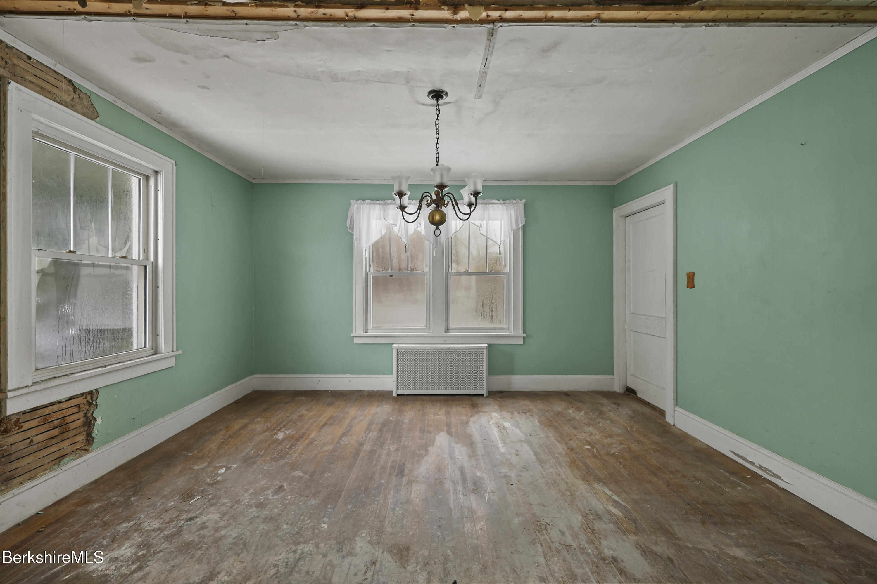 21 Ensign Avenue Pittsfield, MA 01201 - Photo 7 of 33 an empty room with wooden floor chandelier and windows