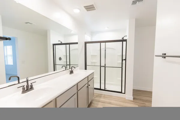 a bathroom with a sink mirror and a bathtub