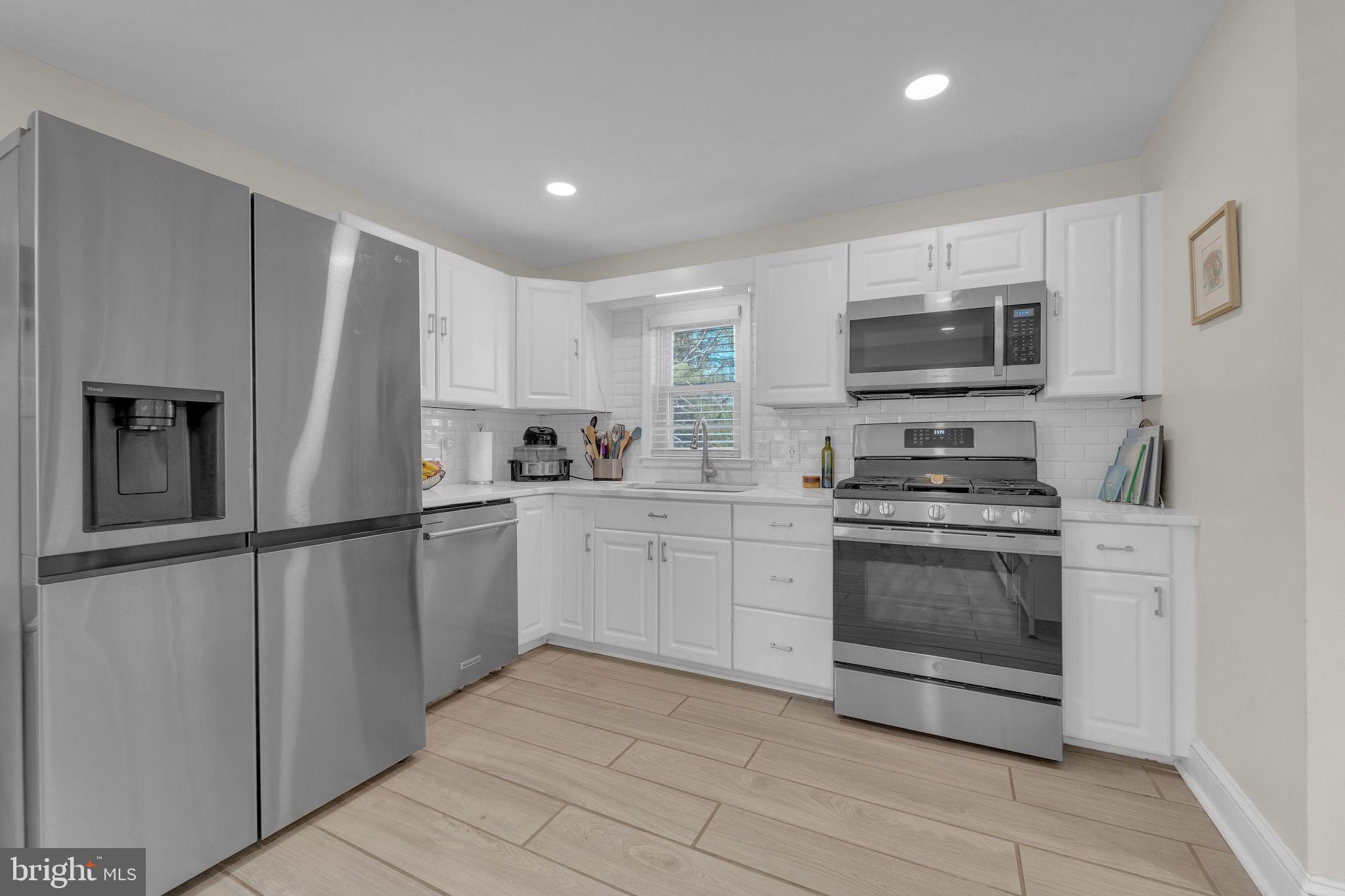 535 Chestnut Avenue Lindenwold, NJ 08021 - Photo 6 of 6 a kitchen with stainless steel appliances a refrigerator sink and microwave
