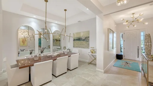 a living room with furniture chandelier and a fireplace