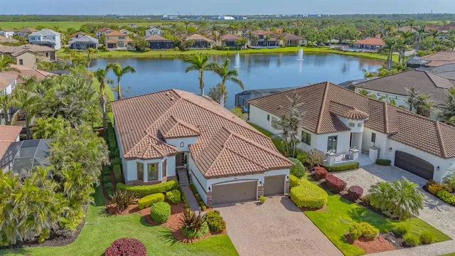 an aerial view of house with yard and lake view