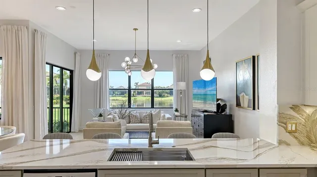 a living room with furniture and a floor to ceiling window