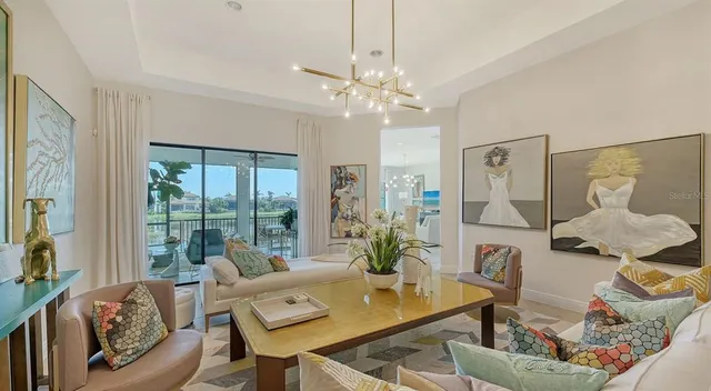 a living room with furniture and a chandelier