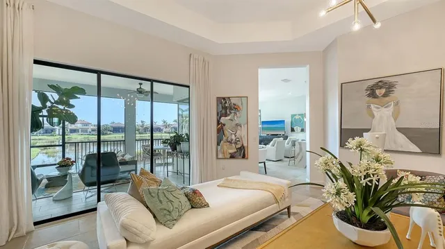 a living room with furniture chandelier and large windows