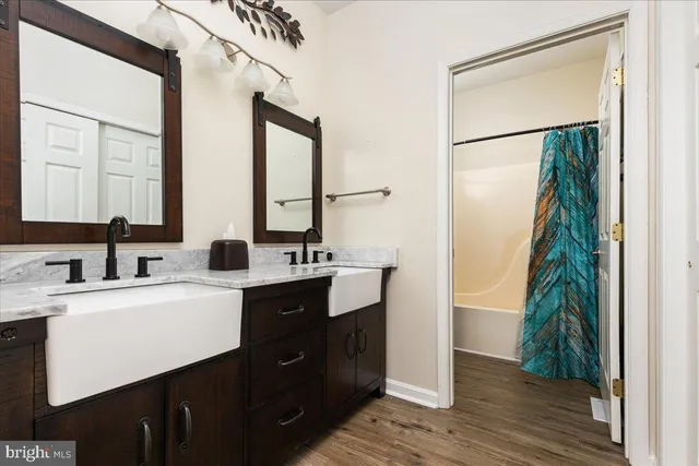 a view of bathroom with a sink and mirror