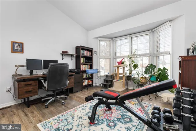 a view of a workspace with furniture and a window
