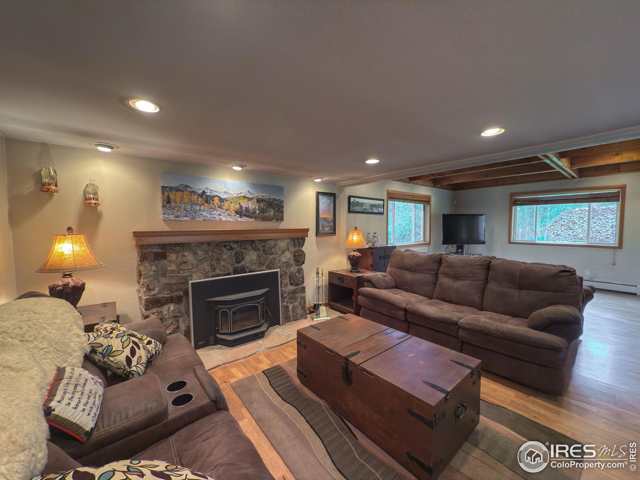 14884 Rist Canyon Road Bellvue, CO 80512 - Photo 11 of 40 a living room with furniture and a fireplace