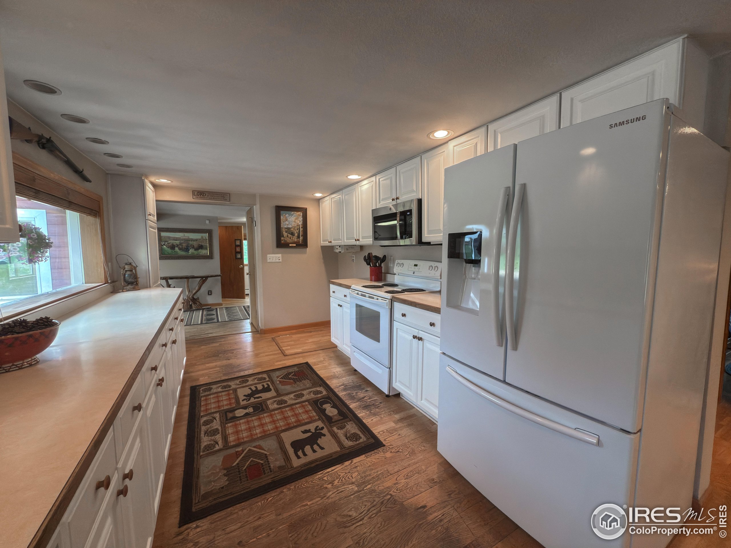 14884 Rist Canyon Road Bellvue, CO 80512 - Photo 14 of 40 a kitchen with stainless steel appliances granite countertop a refrigerator a stove and a sink