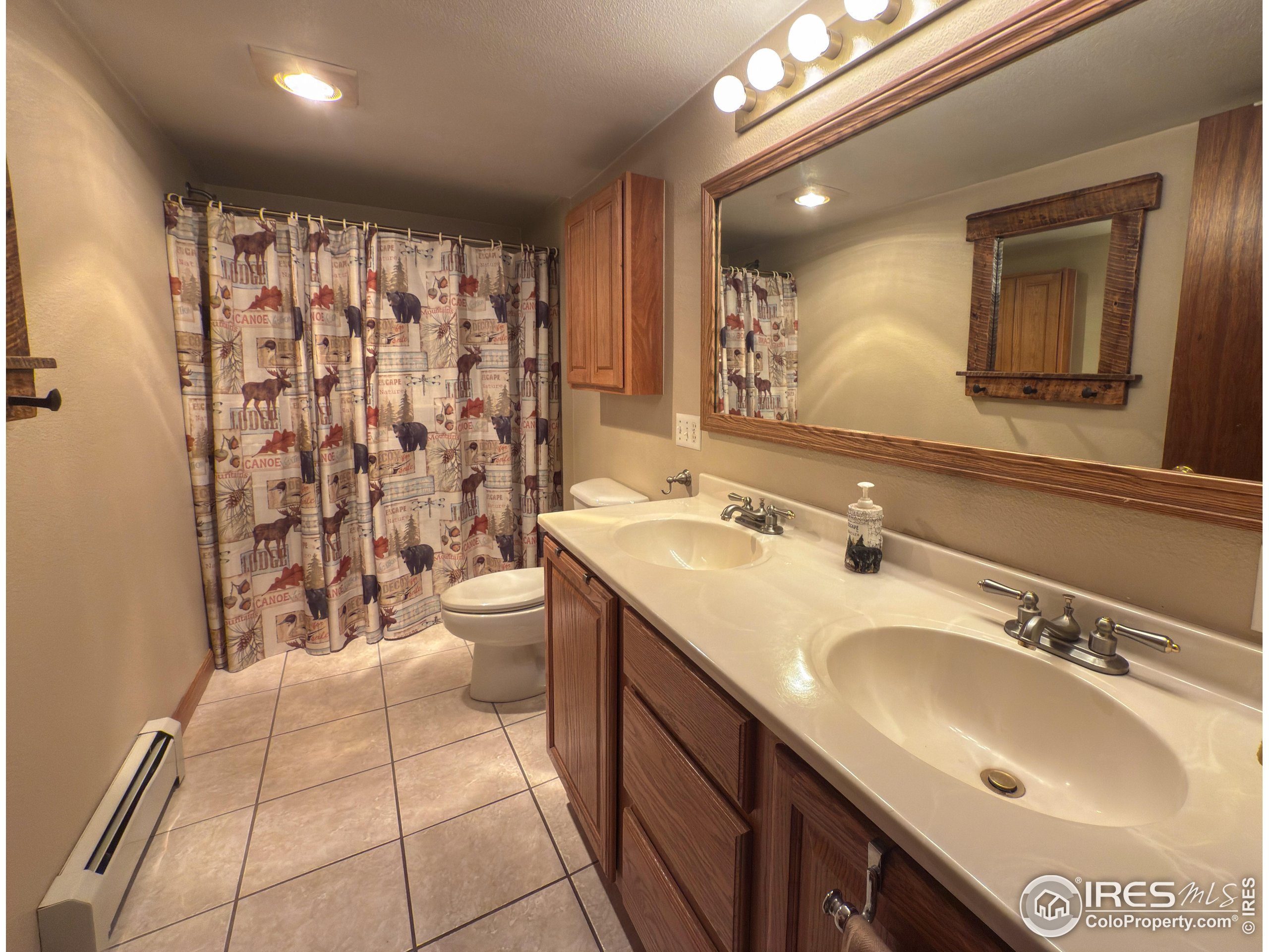 14884 Rist Canyon Road Bellvue, CO 80512 - Photo 16 of 40 a bathroom with a sink toilet and shower