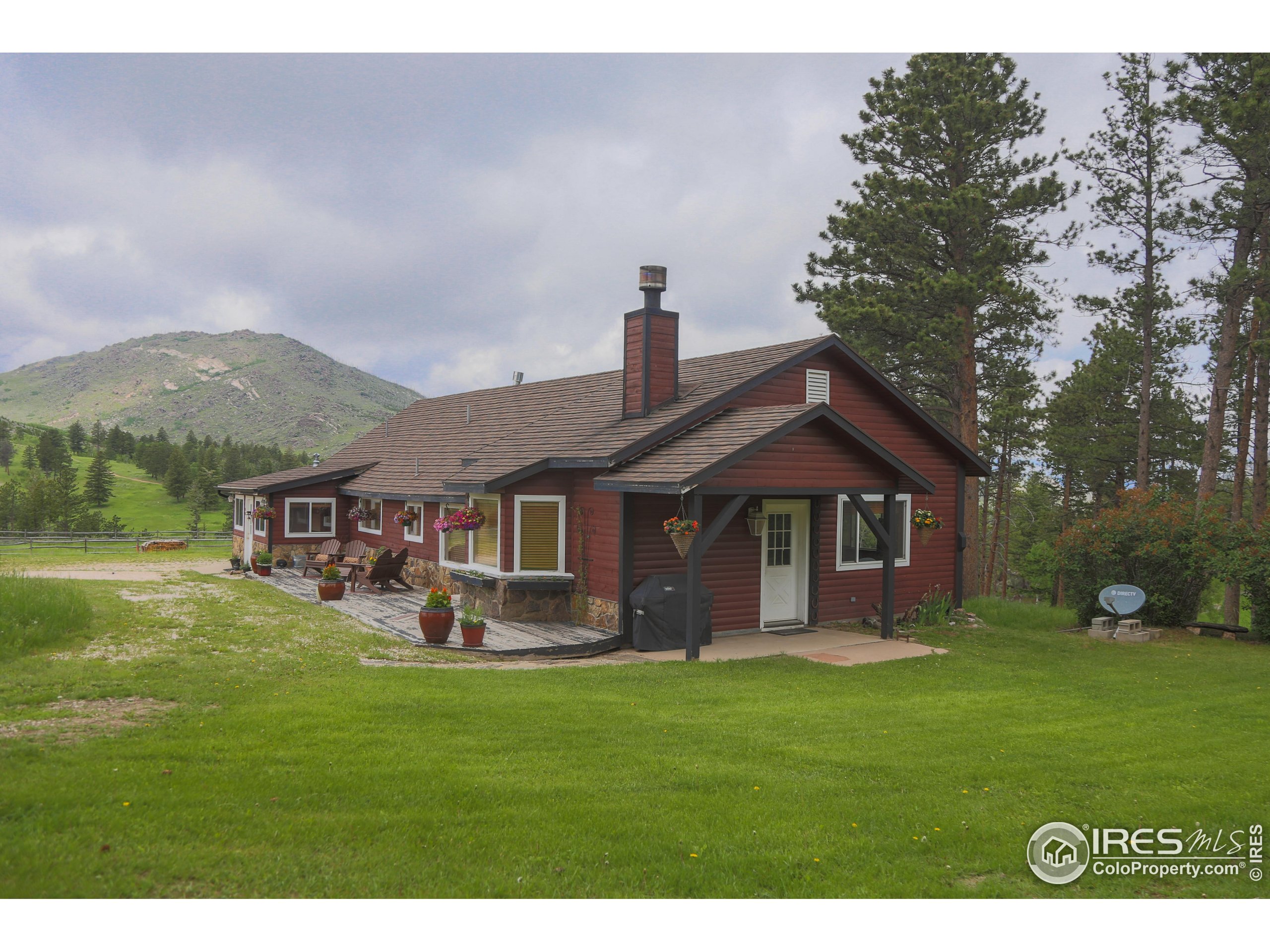14884 Rist Canyon Road Bellvue, CO 80512 - Photo 8 of 40 a front view of a house with a yard