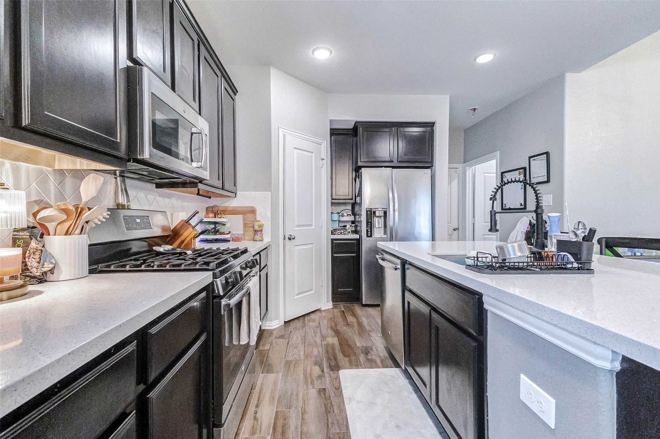 3210 Montclair Orchard Trace Spring, TX 77386 - Photo 14 of 38 a kitchen with stainless steel appliances granite countertop a sink stove and refrigerator