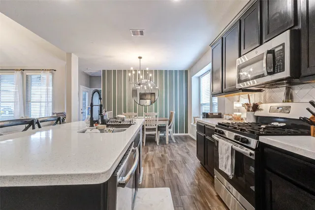 a kitchen with a sink stainless steel appliances and cabinets