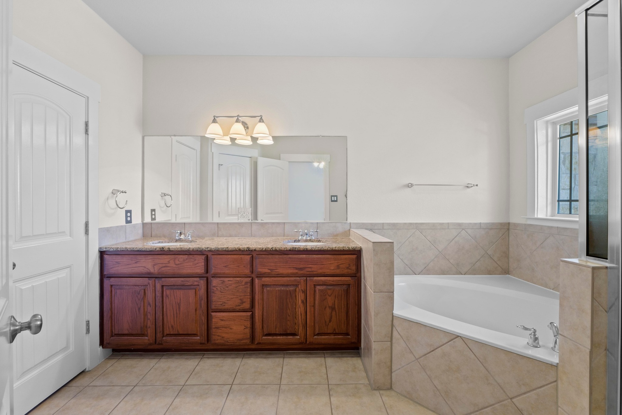 2930 Grand Oaks Loop, Unit 603 Cedar Park, TX 78613 - Photo 16 of 29 Full bath with double vanity, a garden tub, seperate shower, and light tile-patterned floors