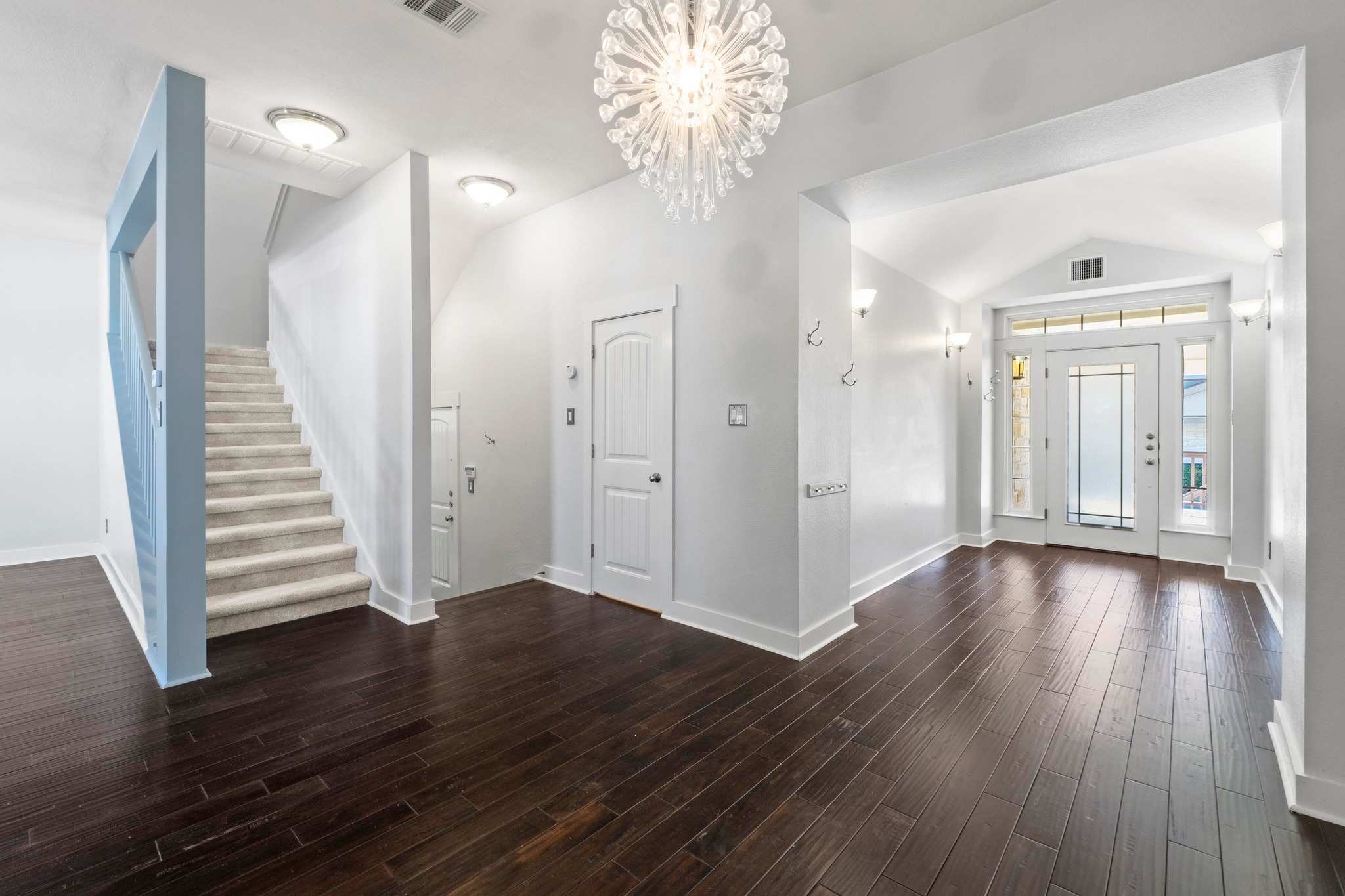 2930 Grand Oaks Loop, Unit 603 Cedar Park, TX 78613 - Photo 6 of 29 Foyer entrance with suspended lighting, vaulted ceiling, and dark wood finished floors