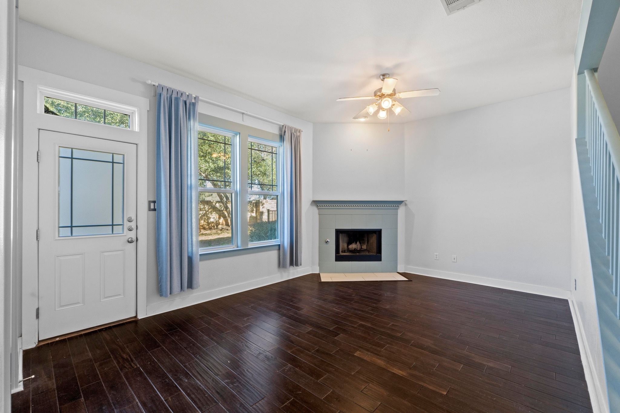 2930 Grand Oaks Loop, Unit 603 Cedar Park, TX 78613 - Photo 7 of 29 Living room featuring a ceiling fan, dark wood finished floors, and a fireplace