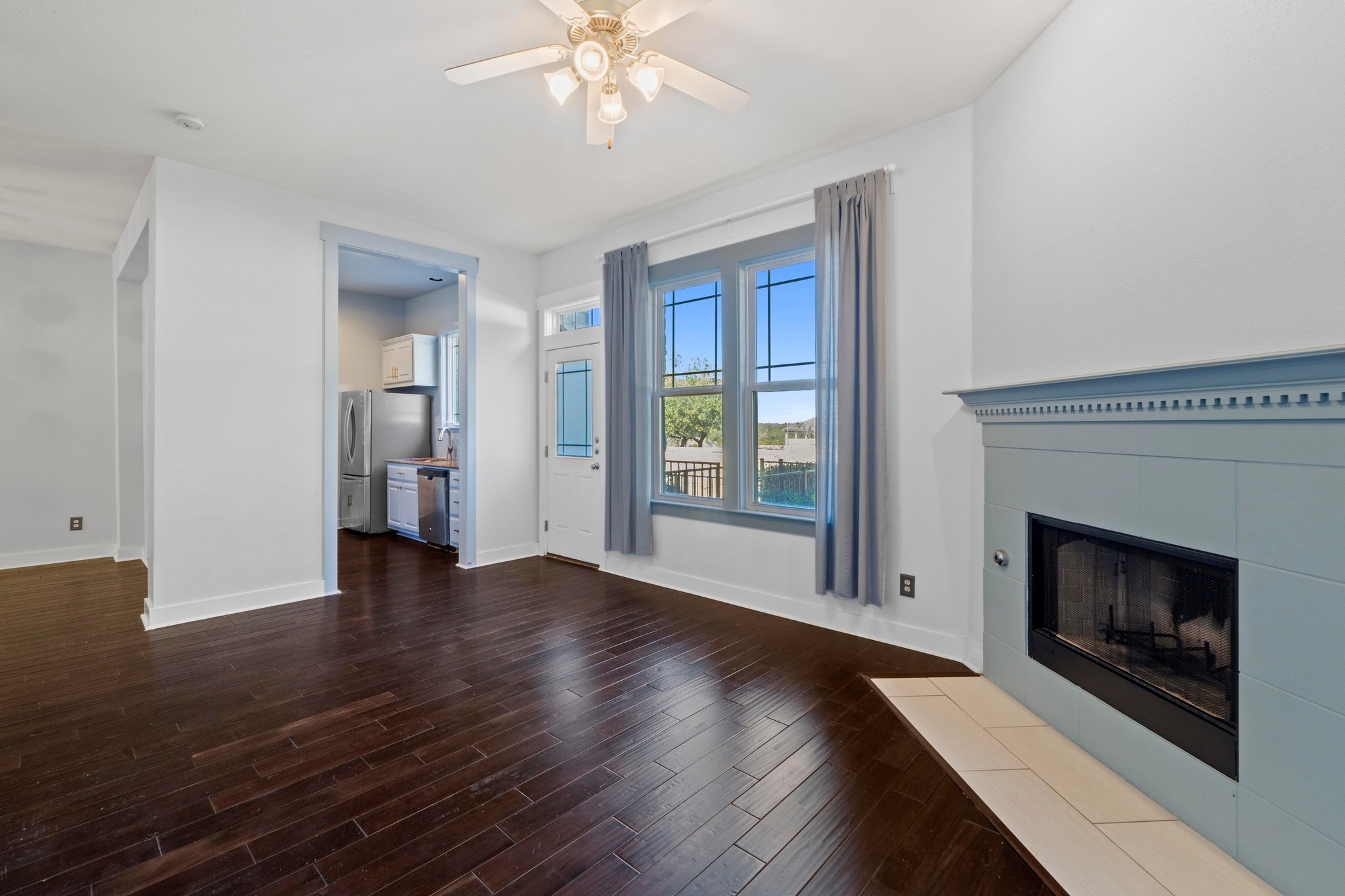 2930 Grand Oaks Loop, Unit 603 Cedar Park, TX 78613 - Photo 8 of 29 living room featuring a tile fireplace, dark wood finished floors, and ceiling fan