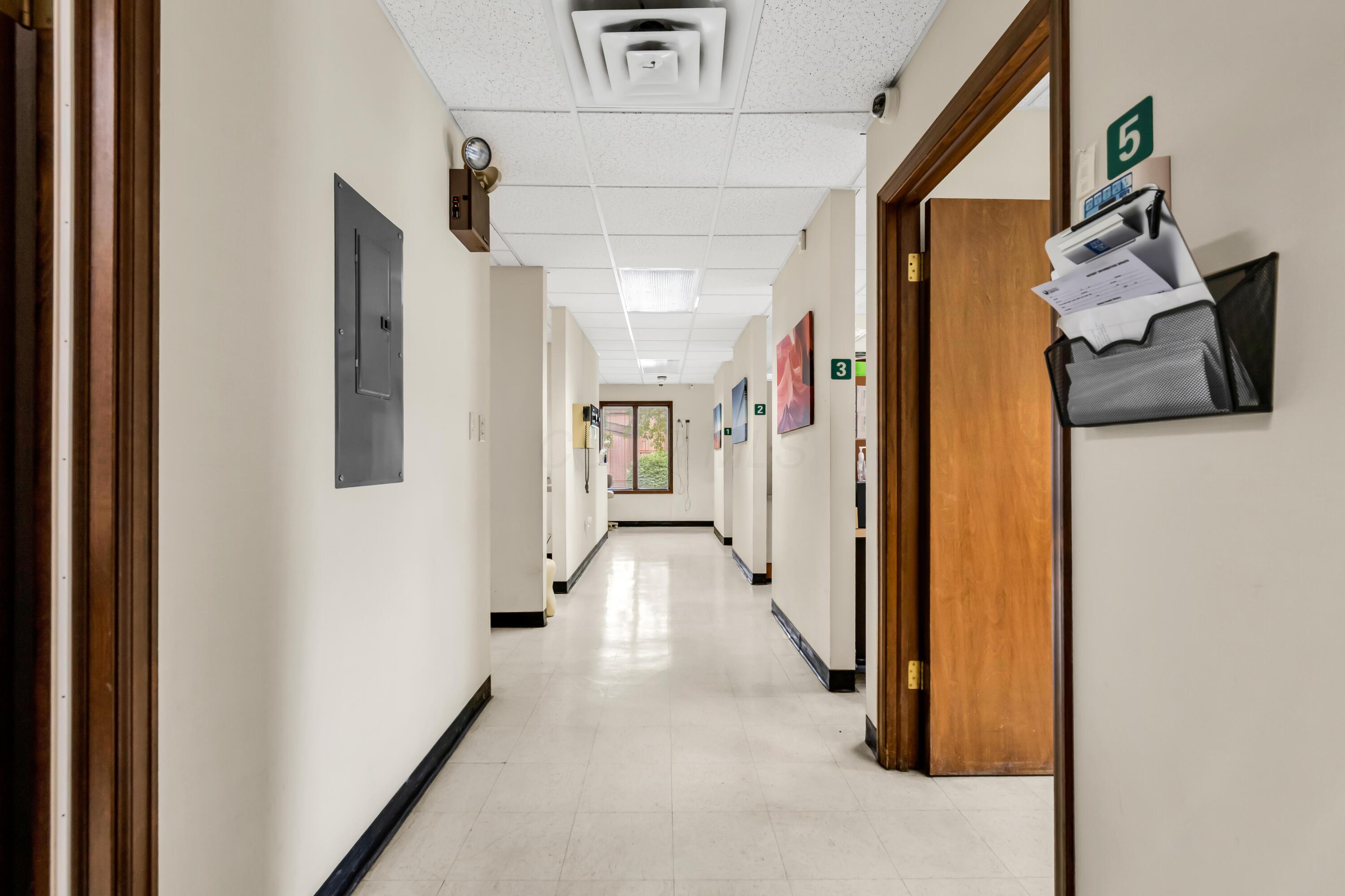 1240 Crescent Heights Road Marion, OH 43302 - Photo 31 of 60 • Neutral vinyl flooring • Ivory painted walls • Side door to parking lot • Acoustic ceiling tiles • Fluorescent lighting