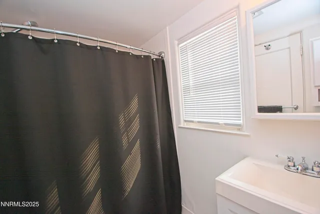 a bathroom with a shower and a sink