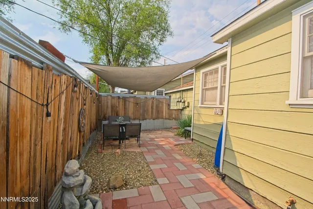 a backyard of a house with outdoor seating