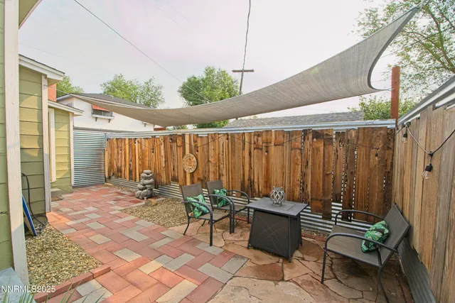 a backyard of a house with table and chairs