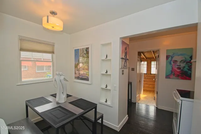 a view of a workspace with furniture and window