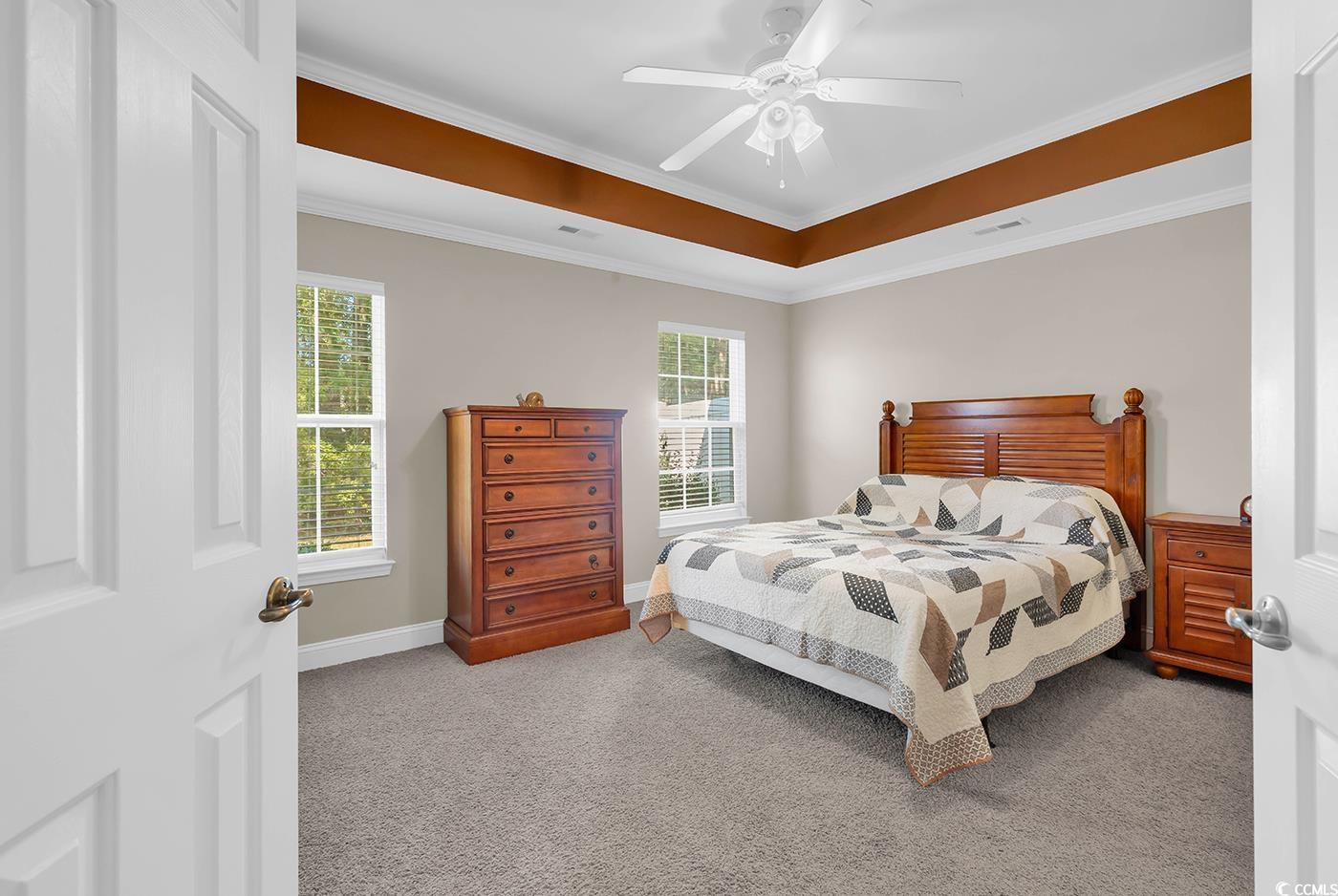 641 Botany Loop, Unit 63 Murrells Inlet, SC 29576 - Photo 14 of 40 Carpeted bedroom featuring crown molding, ceiling fan, and a tray ceiling