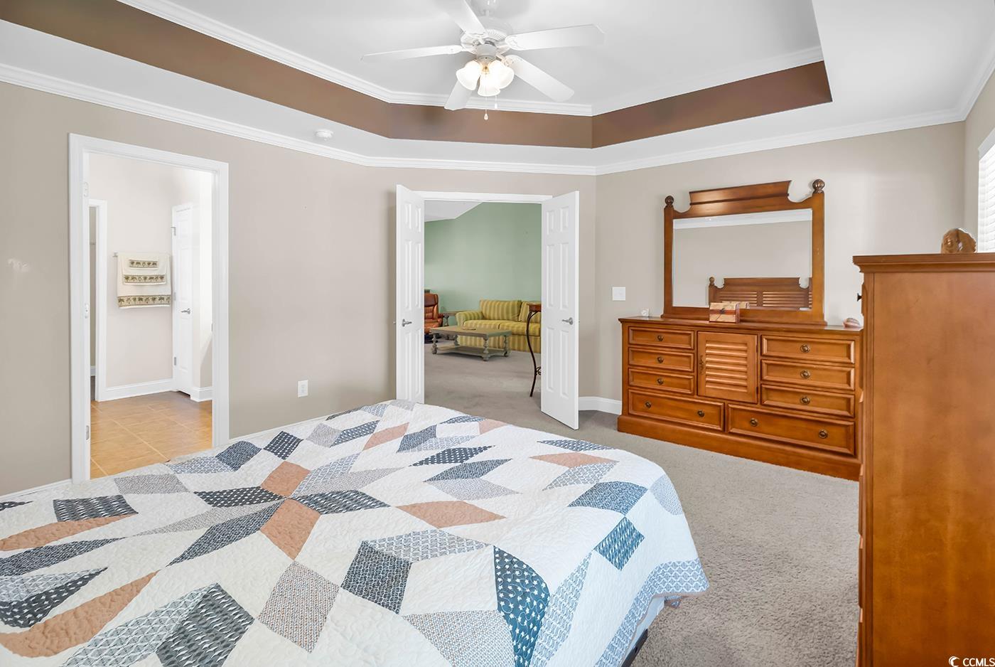 641 Botany Loop, Unit 63 Murrells Inlet, SC 29576 - Photo 15 of 40 Bedroom with ornamental molding, a raised ceiling, light carpet, and ceiling fan