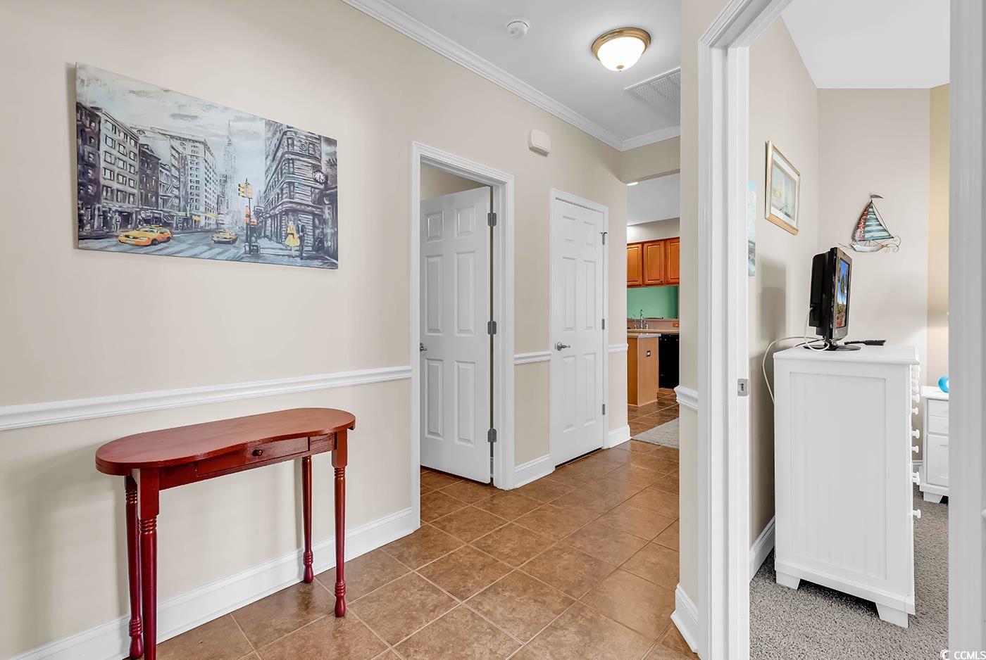 641 Botany Loop, Unit 63 Murrells Inlet, SC 29576 - Photo 22 of 40 Hallway with crown molding and light tile patterned floors