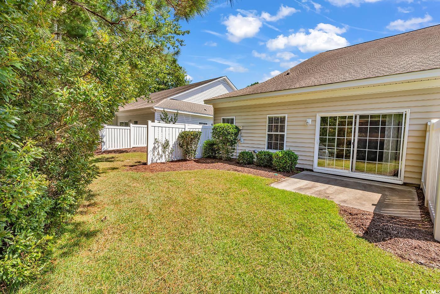 641 Botany Loop, Unit 63 Murrells Inlet, SC 29576 - Photo 32 of 40 Rear view of property featuring a patio and roof with shingles