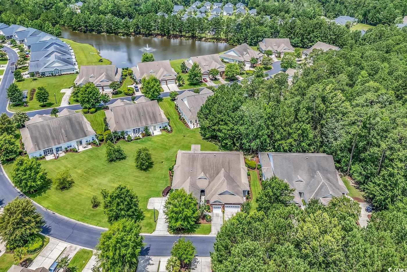 641 Botany Loop, Unit 63 Murrells Inlet, SC 29576 - Photo 34 of 40 Aerial view of residential area featuring a nearby body of water and a tree filled landscape