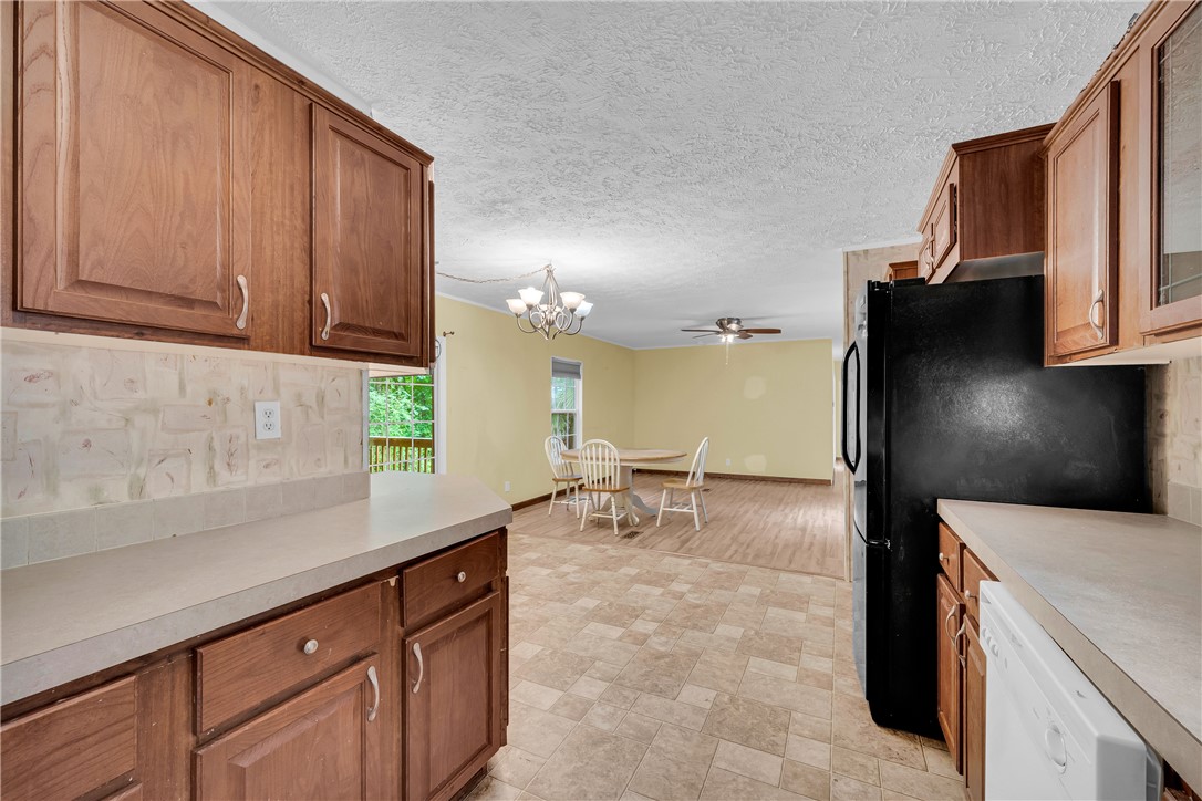 383 Rocky Knoll Road Walhalla, SC 29691 - Photo 25 of 50 Kitchen offers ample cabinetry and counter space, flowing into a bright dining and living area.